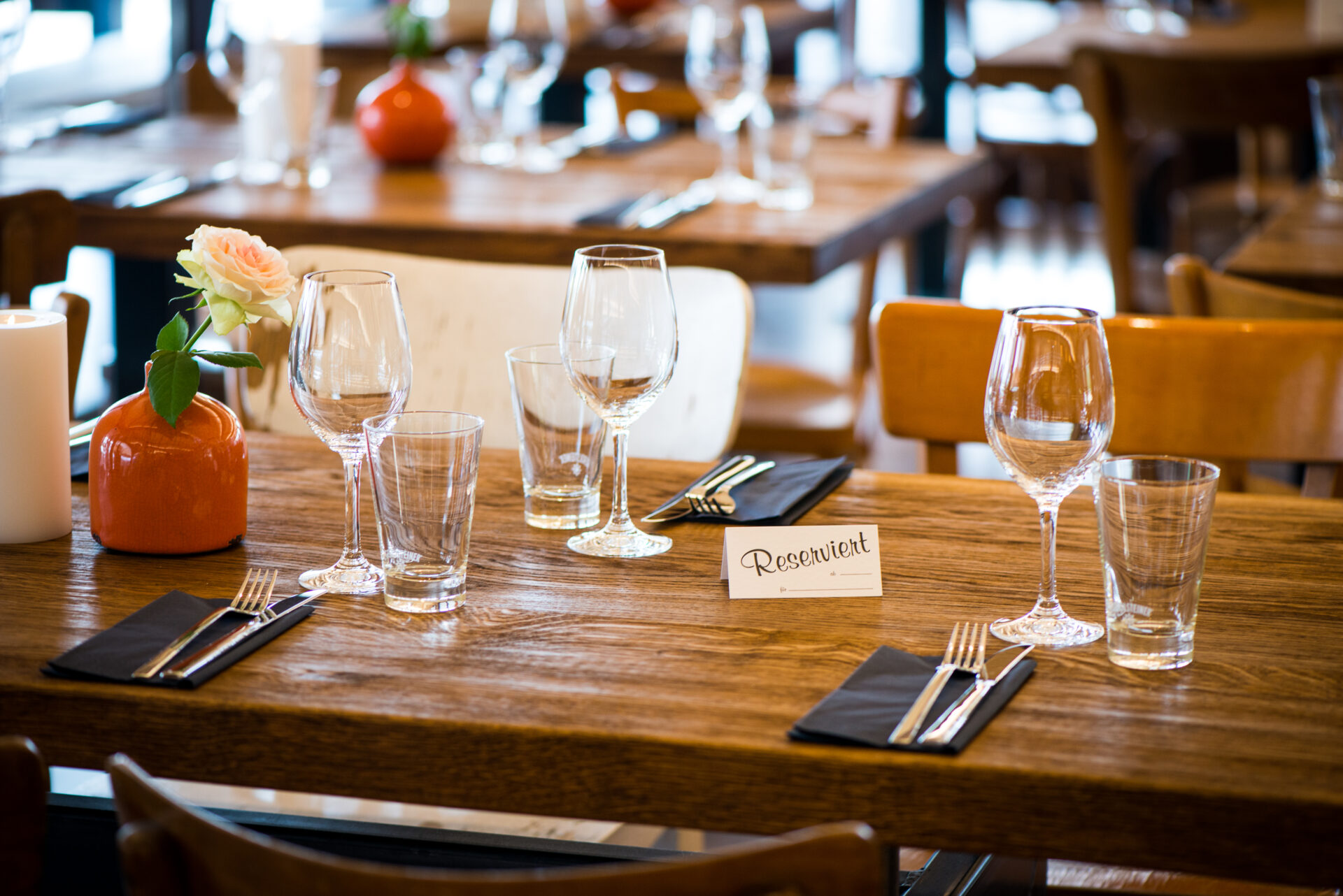 Eingedeckter Tisch im Seehaus Langenfeld mit Gläsern, Besteck und Serviette. Auf dem Tisch ist ein 
